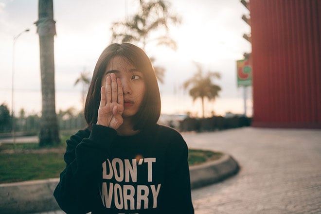 Woman covering her right eye