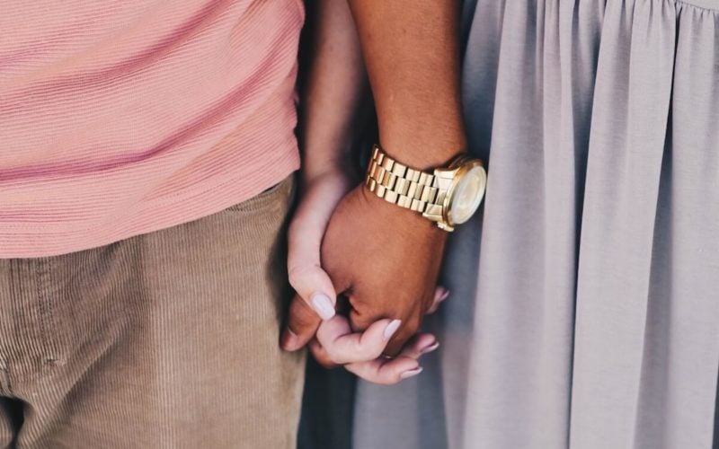 couple holding hands and standing together closely