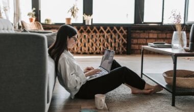 woman working in living room looking at computer