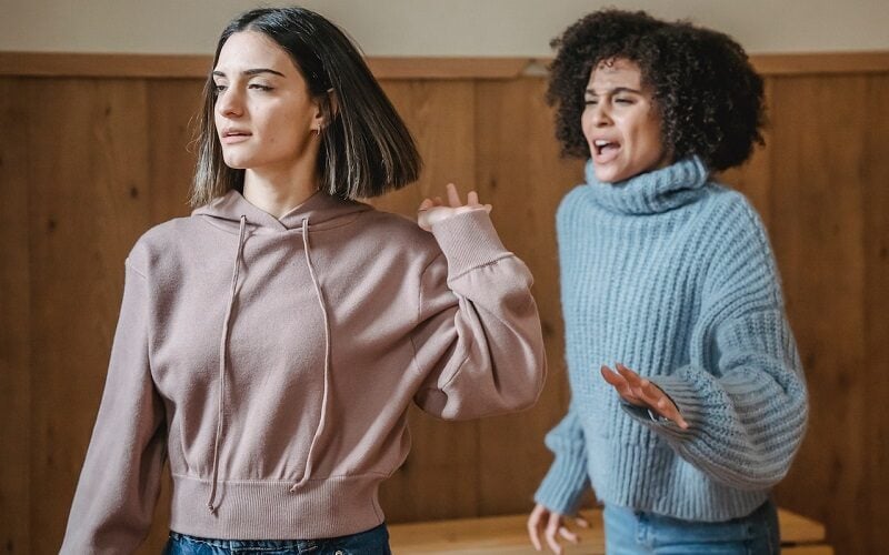 Two woman arguing, on is walking away