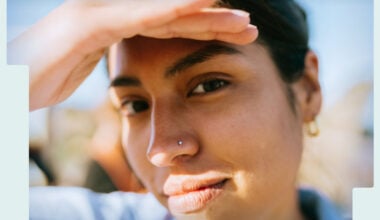 woman-shading-her-face-from-the-sun-with-hand